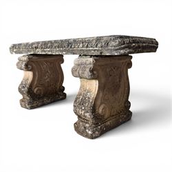 Weathered cast stone three-piece garden bench, with rectangular seat with egg-and-dart moulded edge, raised on end supports decorated with S-scrolls and fruiting vines