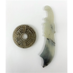 A white Hetian and black jade bi disc with carved detail, D5.5cm, together with a white Hetian and black jade carved dagger, L14cm. (2).