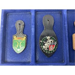Twelve French military metal badges mounted on leather fobs including Legion, Artillery, Parachutist, Air Force, Infantry etc
