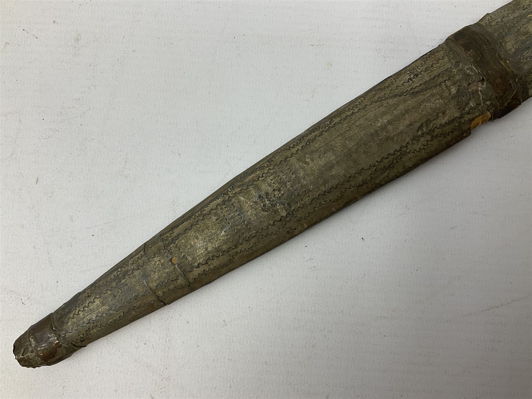 19th century Khanjali dagger, 33.5 cm double edged fullered blade with stamped makers marks, ornate cast grip, with engraved white metal scabbard, 46cm overall