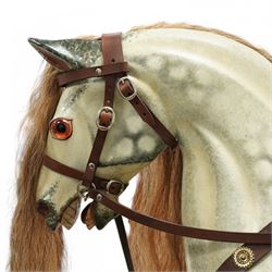 Frederick Henry Ayres (F H Ayres, London) - Late Victorian large carved wooden rocking horse, in dapple grey paint finish, decorated with glass eyes, leather reins, stirrup and saddle, indented hooves, on rockers united by chamfered stretchers and boarded base, c.1890