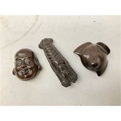 Group of ten Japanese netsukes, comprising eight carved wooden examples, and two ivorine examples, of various form, examples modelled as pigs, owl, mouse with tortoise upon its back, birds, rabbit, etc. 