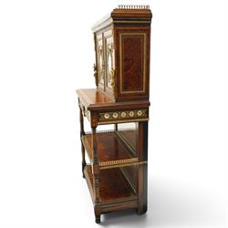 Fine late 19th century Aesthetic Movement ebony and amboyna cabinet on stand with parcel-gilt detail, the moulded cornice with pierced gilt-brass three-quarter gallery above a pair of panelled doors centred by oval porcelain portrait plaques within gilt-metal ribbon-tied frames, the doors further enriched with gilt-metal foliate mounts and flanked by classical figural terms, enclosing a shelved interior, the projecting lower section with amboyna top above a frieze drawer set with a series of floral porcelain roundels within pierced gilt-metal mounts and a central oval floral plaque, raised on turned and fluted supports with gilt-heightened detail, the mirrored back behind two amboyna shelves with pierced gilt-brass galleries, on turned feet