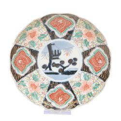 Group of 19th century Japanese Imari porcelain, Meiji period, comprising pair of lobed dishes, decorated stylised reserves and painels in blue and gilt upon a red ground, H6.5cm D21.5cm, a pair of plates of circular lobed form, decorated with a central panel depicting a vase beneath pine branches, and surrounded by panels of flowers and stylised quatrefoil shapes, D21cm, and another similar example painted with a character in underglaze blue to the centre, with character mark beneath, D22cm, each with character marks beneath               