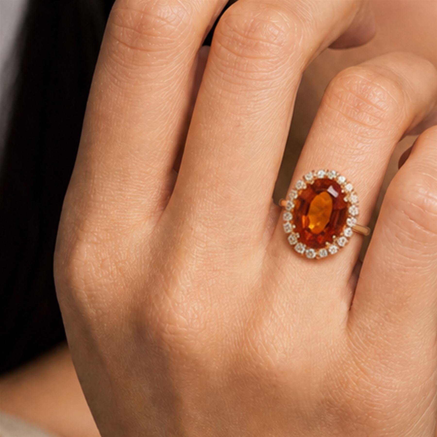 18ct gold citrine and diamond cluster ring, single oval cut citrine of approx 6.90 carat, surrounded by twenty round brilliant cut diamonds, stamped, total diamond weight approx 0.60 carat