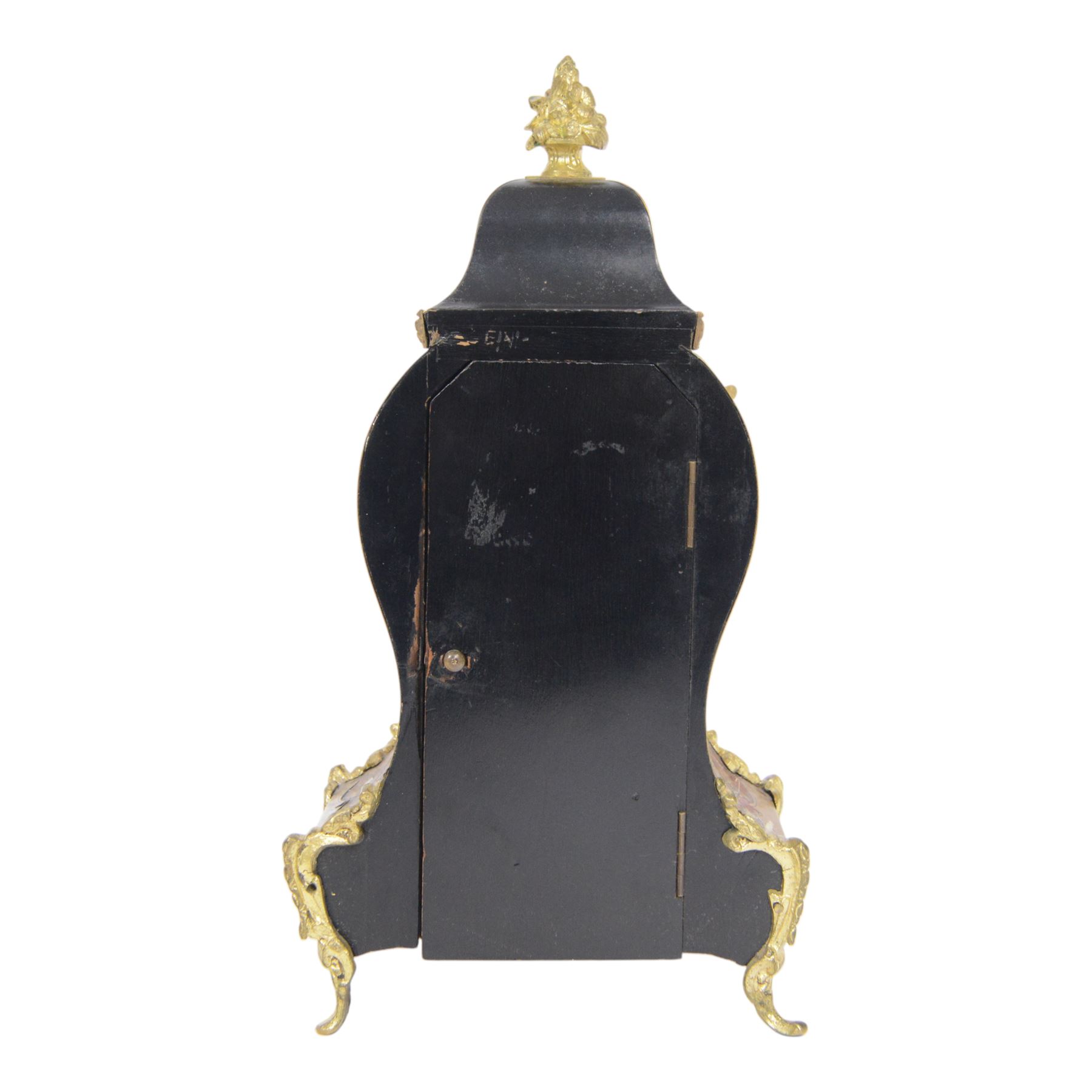 Louis XV-style gilt-bronze mounted turtleshell boulle mantel clock, the case of typical waisted form, gilt bronze foliate scroll and rocaille mounts, raised on scroll feet. Eight-day Paris movement signed “Rollin à Paris”, with outside count-wheel striking half-hourly on a single bell, the going train with anchor escapement. The circular foliate gilt bronze dial with enamelled Roman hour numerals and twin winding apertures, fitted with pierced blue steel hands and bevelled glass cover, with pendulum and key, circa 1860