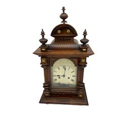 A late 19th century twin train striking mantle clock manufactured in Germany by Phillip Hass & Sohn c1890, in an oak case with an arched pediment and three turned finials, with a break arch door and etched silvered dial, Roman numerals and minute track, with steel spade hands, eight-day countwheel striking movement striking the hours and half-hours on a coiled gong. With pendulum.

	




