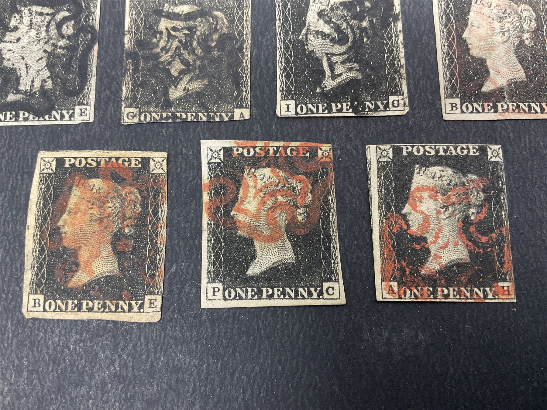 Seven Great Britain Queen Victoria penny black stamps, three with black and four with red MX cancels