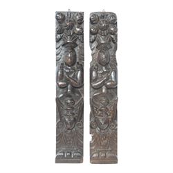 Pair of 17th century carved oak terms, each depicting a figure with headpiece and arms cro...