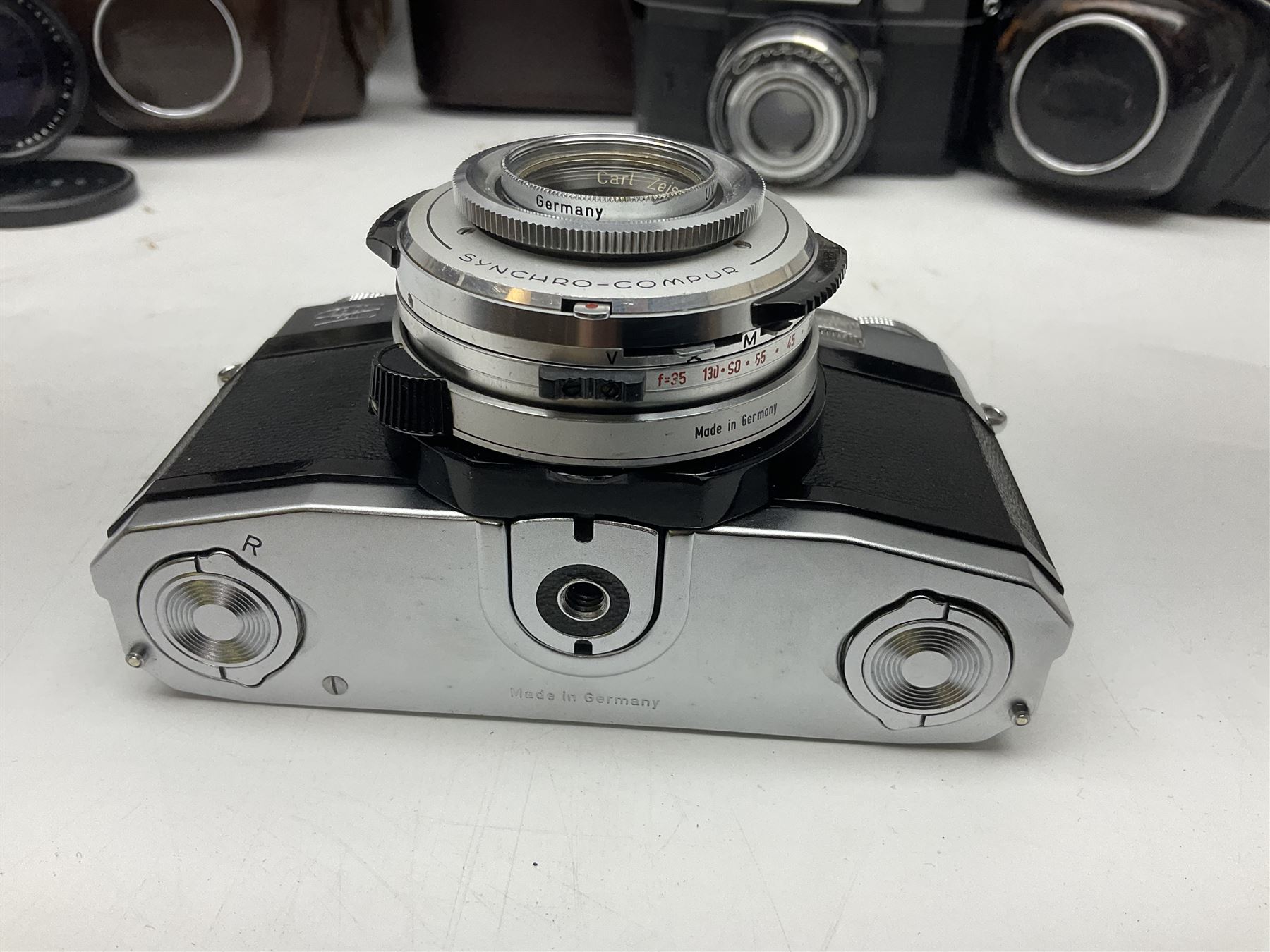 Four Zeiss Ikon camera bodies, to include, Contaflex Super B camera body, serial no. B31591, with 'Carl Zeiss Tessar 2.8/50 lens, serial no.3425553, Contaflex Super BC camera body, serial no. P81728, with 'Carl Zeiss Tessar 2.8/50' lens, serial no 4822280, etc, together with three cased lenses; 'Carl Zeiss Pro-Tessar 1:4 f=115mm' lens, serial no 3734740, 'Carl Zeiss Pr-Tessar 1:3.2 f=85mm' lens, serial no. 3647764 and 'Carl Zeiss Pr-Tessar 1:3.2 f=35mm' lens, and other Zeiss Ikon equipment 
