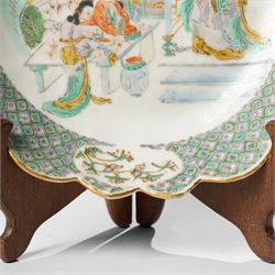 Chinese Kangxi period famille verte bowl, painted with seven figures in a pavilion interior, in Cantonese style border with foliate rim, the exterior painted with similar scenes, D24cm