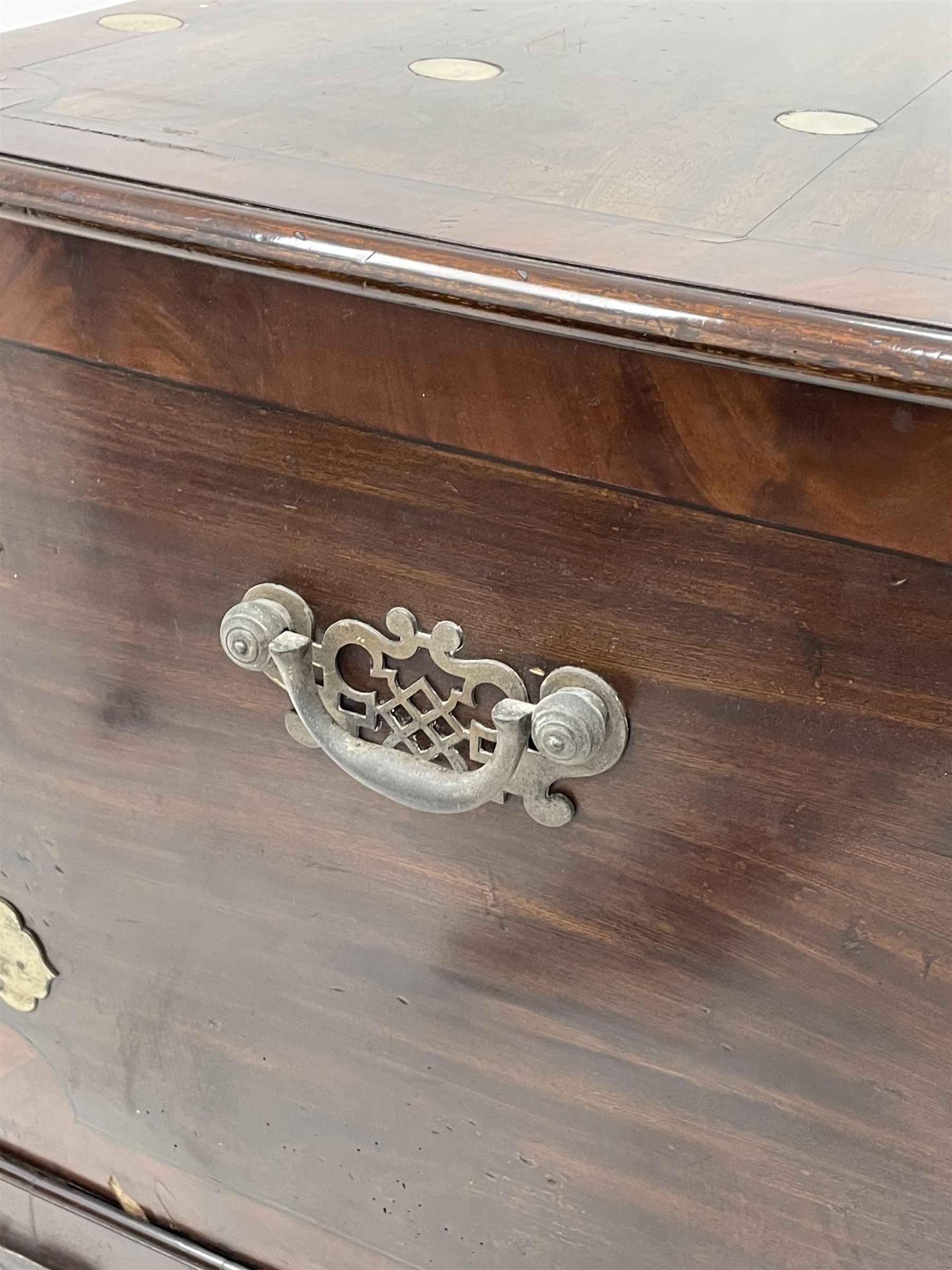 19th century camphor wood and mahogany silver chest, the hinged banded top with circular brass mounts which secure the interior strap hinges, fretwork metal strapping to the corners, on stand with plain frieze and acanthus carved cabriole ball and claw feet