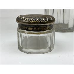 Edwardian silver mounted purse, with circular panel engraved with initials, and hammered finish, hallmarked William Comyns & Sons, London 1903, H14cm, together with three dressing table glass jars with hallmarked silver covers, and a hallmarked silver mounted buffer 