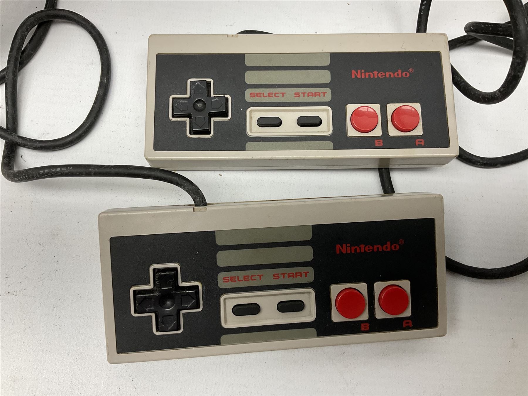 Nintendo Entertainment System (1985) console with two controllers, accessories and instruction booklet. NES Games ‘Duck Hunt’ with Nintendo Zapper gun, ‘Pinball’ and ‘Super Mario Bros.’, all with original sleeves and instruction booklets. NES game ‘Super Mario Bros. 2’ cartridge only