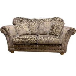 Three seat sofa (W180cm), and matching two seat sofa (W242cm), upholstered in plum fabric decorated with raised floral repeating pattern, with scatter cushions 