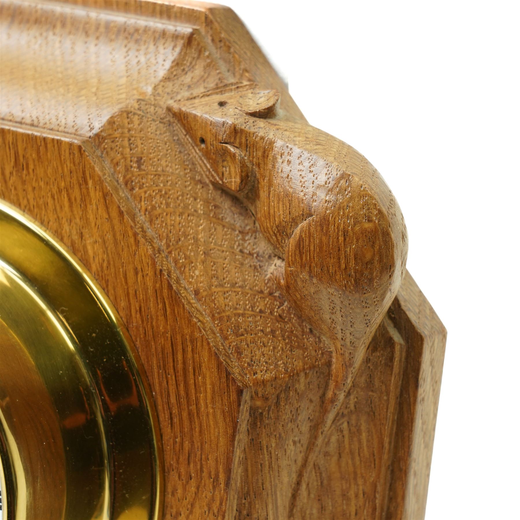 Mouseman - oak wall clock, circular Roman dial in brass drum on moulded octagonal mount, , fitted with battery operated Quartz movement, with carved mouse signature, by the workshop of Robert Thompson of Kilburn