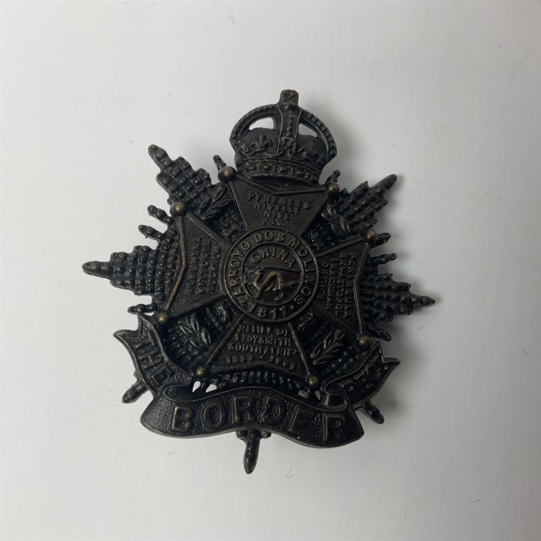 Four Border Regiment cap badges including eleventh battalion (4)