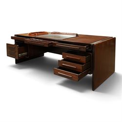 Dyrlund - Santos rosewood office suite, comprising an executive desk and cream leather upholstered swivel chair, the desk with a broad rectangular top with rounded corners, leather writing surface, pen compartments and letter tray, three lockable frieze drawers with fitted interiors above a central kneehole flanked by floating drawer pedestals, the left housing a filing drawer and the right three compartmented drawers, with a full width modesty panel to the reverse, chair raised on a castor base, H 116cm, W 62cm, D 74cm