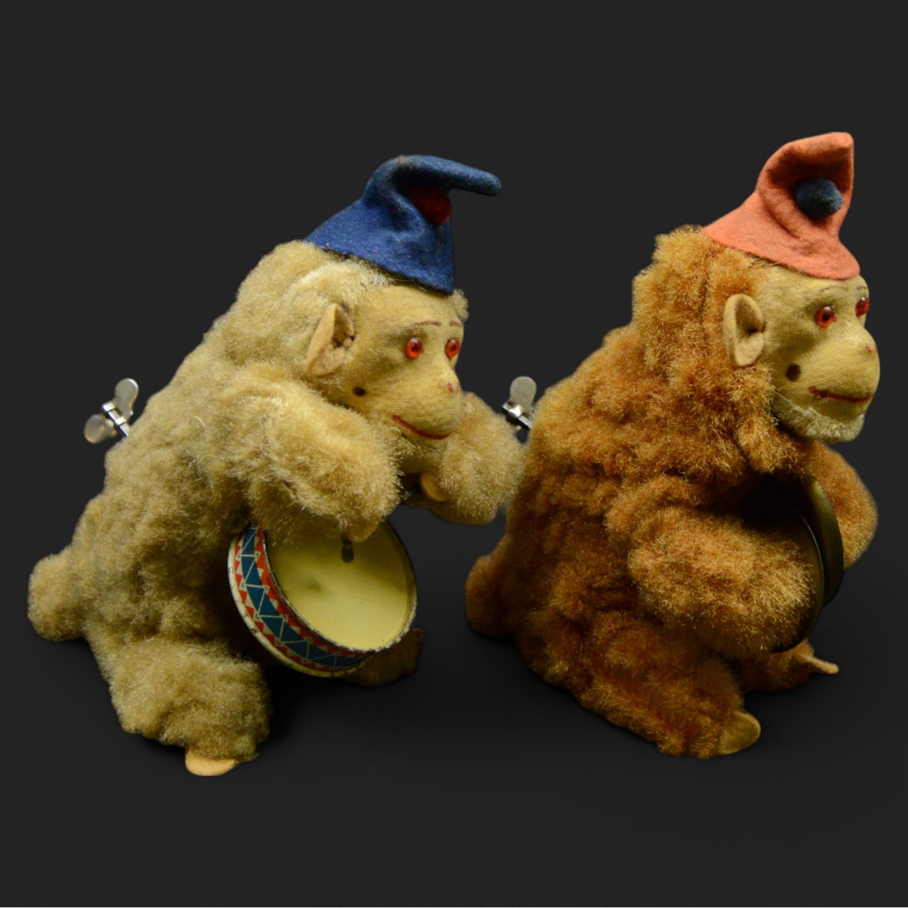 Two West German Urwald-Musik clockwork monkeys, one playing cymbals and the other a drum