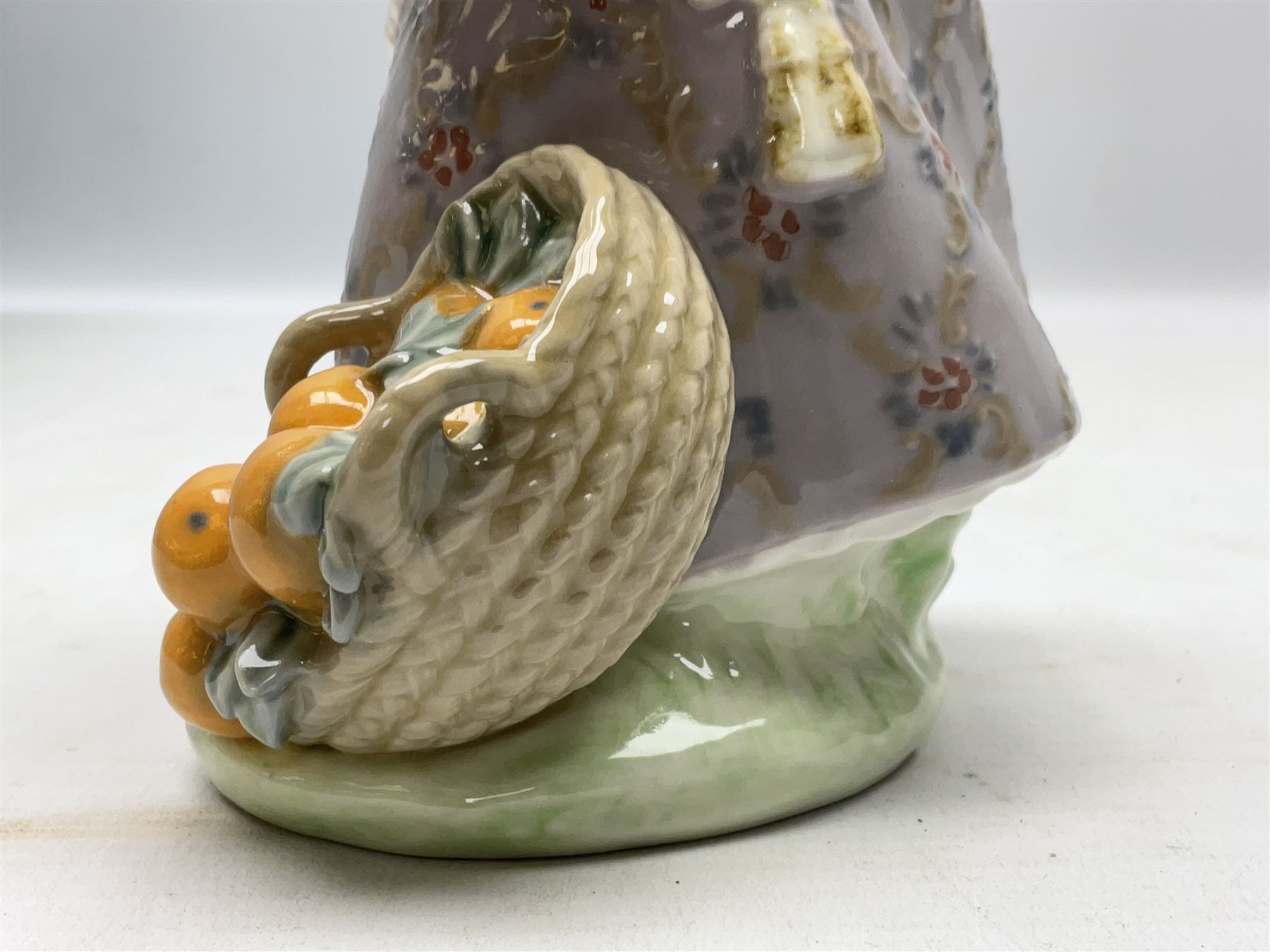 Lladro figure, Miss Valencia, modelled in traditional Valencian dress with basket of oranges, sculpted by Juan Huerta, with original box, no 1422, year issued 1982, year retired 1997, H18cm