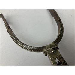 Pair of late 19th century South American iron spurs, engraved silver mounts, with sunburst rowls