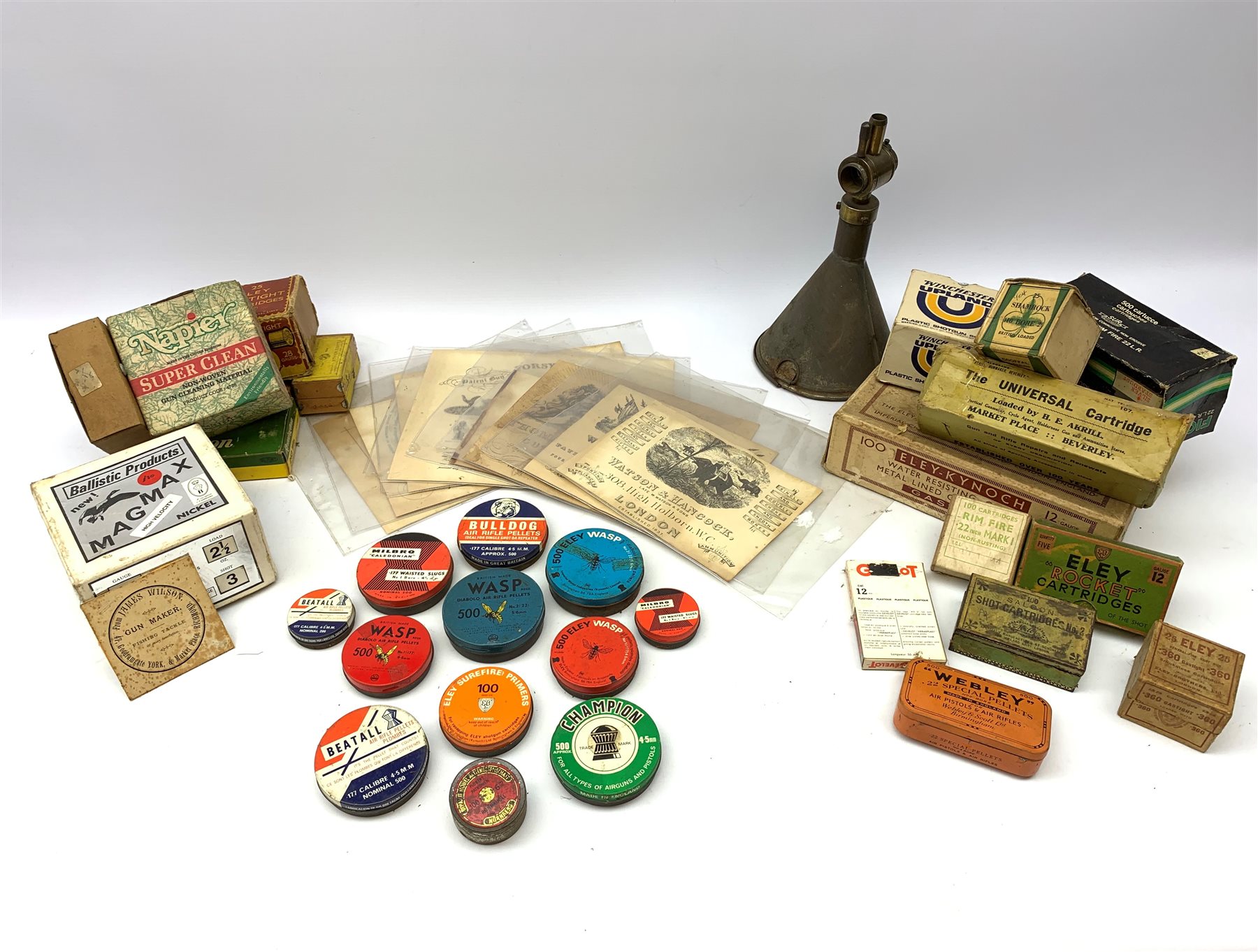 Brass and tin powder magazine by B.E. Chaplin of conical form with glazed see-through nozzle H27cm; eight reprinted gun case labels for Holland & Holland, Thomas Jackson & Son, William Ling, Watson & Hancock, Williams & Powell etc; and quantity of empty cartridge boxes and pellet tins
