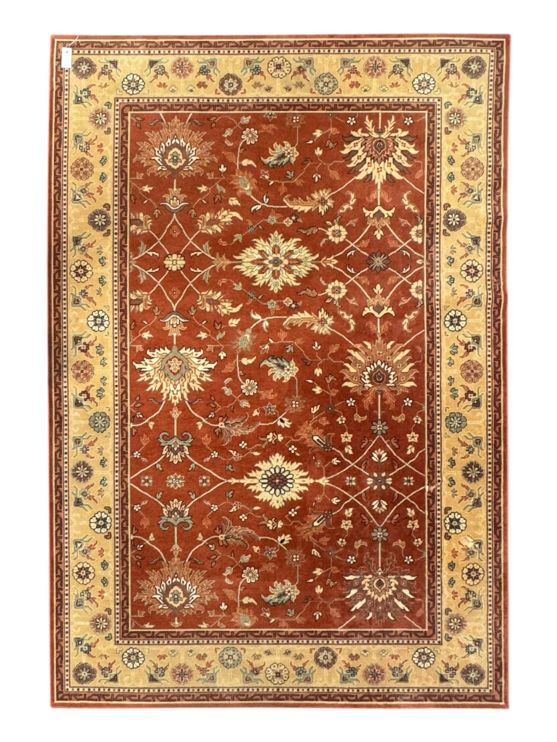 Late 20th century Royal Keshan 'Agra' hand-knotted wool rug, terracotta ground with central floral medallion and scrolling vines, enclosed by a cream border with repeating floral motifs