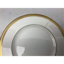 Royal Doulton Royal Gold pattern tea and dinner service for eight, comprising dinner plates, side plates, tea plates, soup bowls, sauce boat and saucer, dessert bowls, coffee cans and saucers, teacups and saucers and two lidded tureens