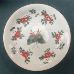 Three Chinese famille verte examples, approximately Yongzheng period, to include two teabowls and two saucers, each decorated with flowers and butterflies, two with sacred fungus mark within double rings, the teabowl with lotus mark, the other indistinct - possibly a Wan mark within lozenge (4)
