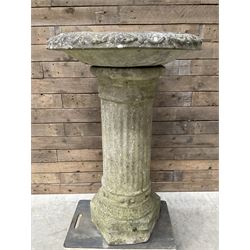 Large cast stone bid bath, raised on corinthian column and mounted on hexagonal base