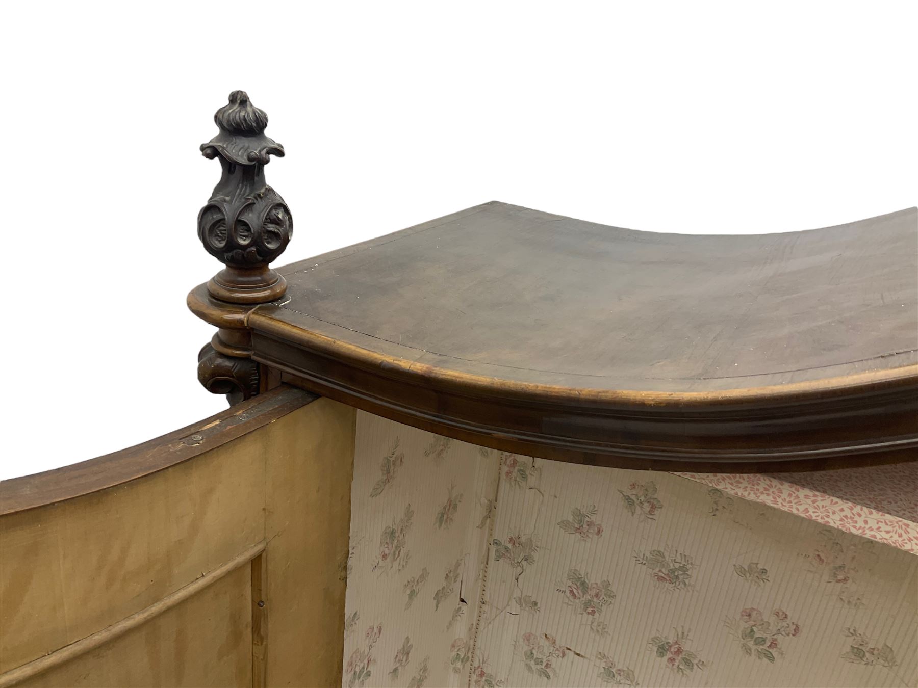 Early 20th century Italian walnut armoire wardrobe, the pierced and scrolling pediment carved with acanthus leaf detail, flanked by two scrolling cartouche with matching corbels below, the two panelled doors with applied carved rinceaux slips, with a central spiral turned upright, enclosing single shelf and hanging rail, raised on scroll feet