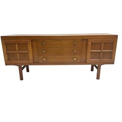 Elliotts of Newbury (EoN) - mid-20th century teak sideboard, fitted with three central drawers flanked by two cupboards, raised on square supports 