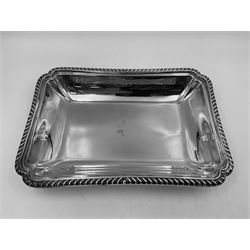 Early 20th century silver entree dish and cover, of rectangular form with shaped corners and oblique gadrooned borders to base and cover, the cover with loop 'bamboo' handle, hallmarked Thomas Bradbury & Sons Ltd, Sheffield 1930, including handle H10.5cm L24.5cm
