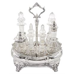 Victorian silver cruet stand, of rounded bombe form with engraved scrolling foliate decoration, the central shaped handle supporting a platform forming seven sections, containing six cut glass bottles, two examples with original silver covers, another with silver gilt cayenne pepper spoon, hallmarked William Evans, London 1883, the whole upon four scroll feet, hallmarked John Evans II, London 1845, H25.5cm L21.5cm