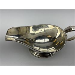 Christofle silver-plated sauce boat, of typical plain form, with capped C scroll handle and engraved anchor crest to body, upon a stepped oval foot, stamped 22 Christofle to base, including handle H14cm