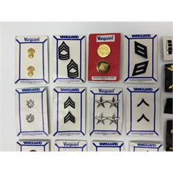 Fifty US rank badges and trade badges; WW2 and Vietnam period; predominantly on sale cards