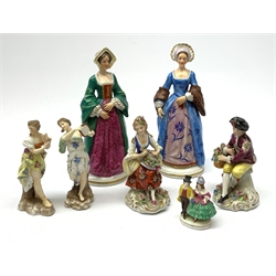Four Sitzendorf figurines, comprising two examples modelled as two of Henry VIII's wives, a smaller pair modelled as seated male and female figures, plus two Continental examples modelled as classical female figures, etc. (7). 