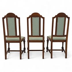 Victorian mahogany extending dining table, rectangular top with chamfered corners above a plain frieze raised on turned reeded legs with castors and two additional leaves, 197cm fully extended, and a set of six early 20th century oak upholstered chairs with drop-in seats, arched panelled back splat and close studded border on turned front legs joined by stretchers, 47x41x109cm 