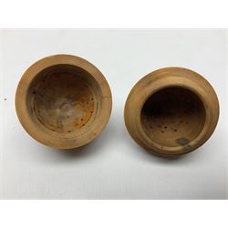 Three 19th century coquilla nut pomanders or flea catchers, each of egg shaped form with carved and pierced decoration and screw threaded join, largest example 6cm