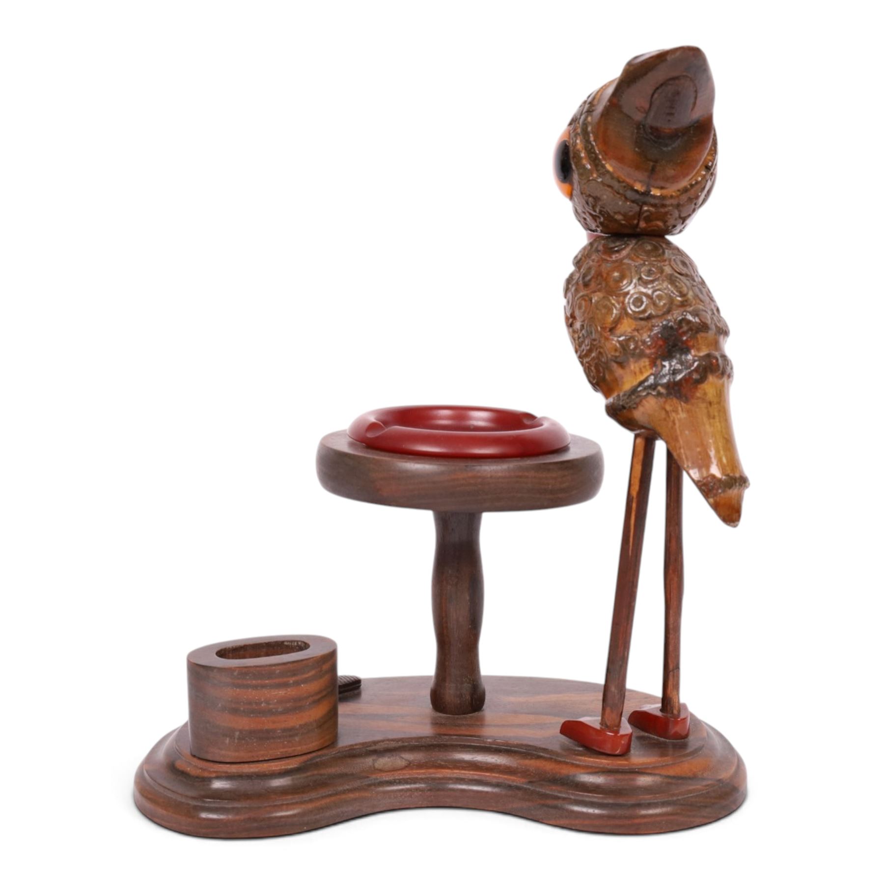 Henry Howell & Co., YZ bird novelty smokers stand, circa 1920-30's, with novelty nut bird with Bakelite beak and tail, with removable Bakelite ashtray on raised wooden plinth, with match holder and striker to the base, stamped YZ TRADE MARK MADE IN ENGLAND to base, 23cm, L21cm  