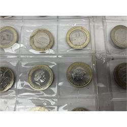 Queen Elizabeth II United Kingdom fifty mostly commemorative two pound coins, housed in two plastic sleeves 