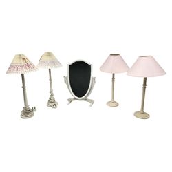 Four white / cream table lamps with pink shades and an ornate mirror of shield form,  mirror H49.5cm