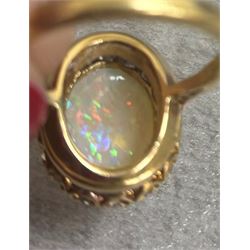 Early 20th century gold opal and diamond cluster ring, single oval cabochon opal, surrounded by sixteen old cut diamonds, stamped 18ct, total diamond weight approx 0.65 carat
