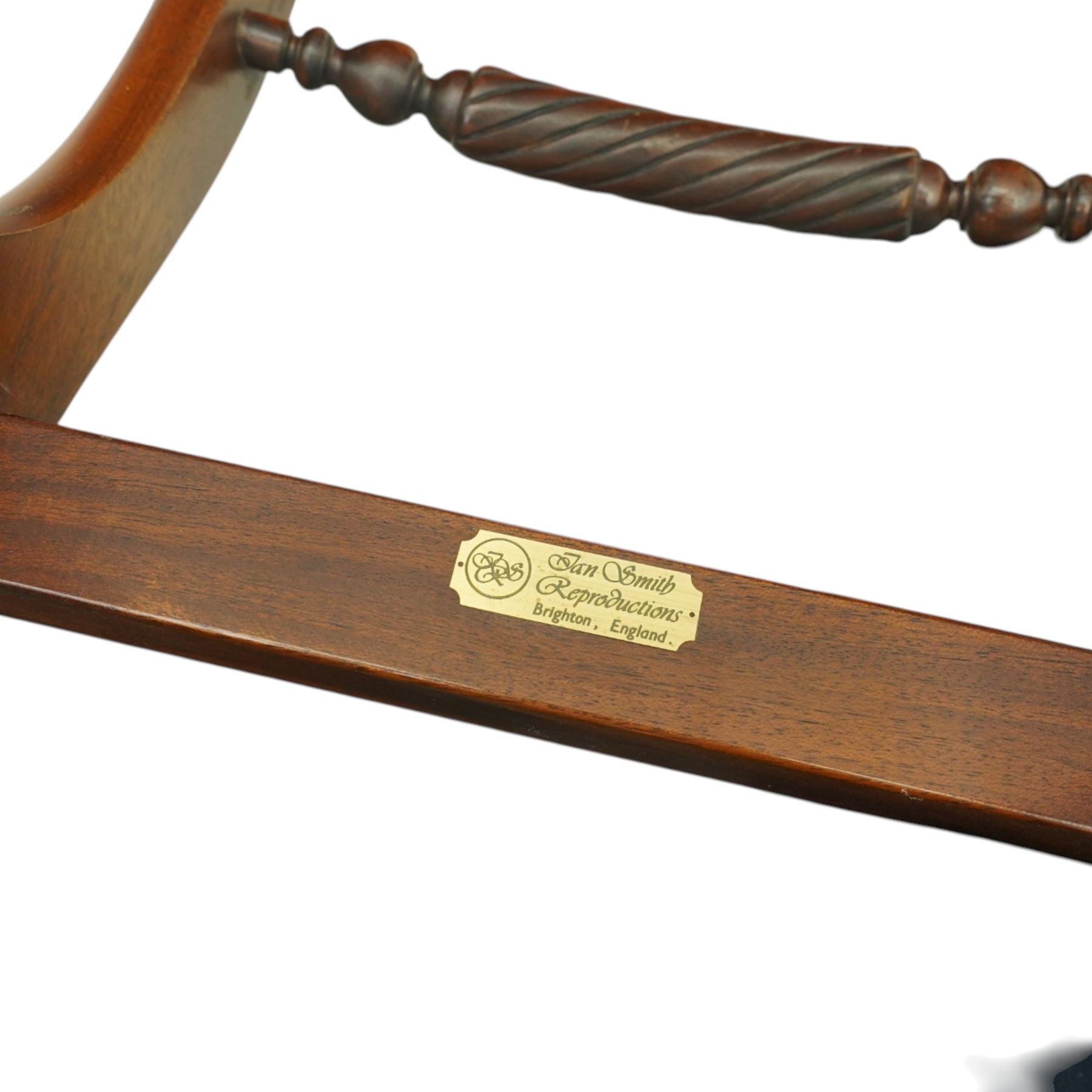 Late 20th century Regency style mahogany dining chairs, set of six comprising four single chairs and two open armchairs, bar backs with figured veneered top rails and turned spindle stretchers, overstuffed seats, on sabre supports