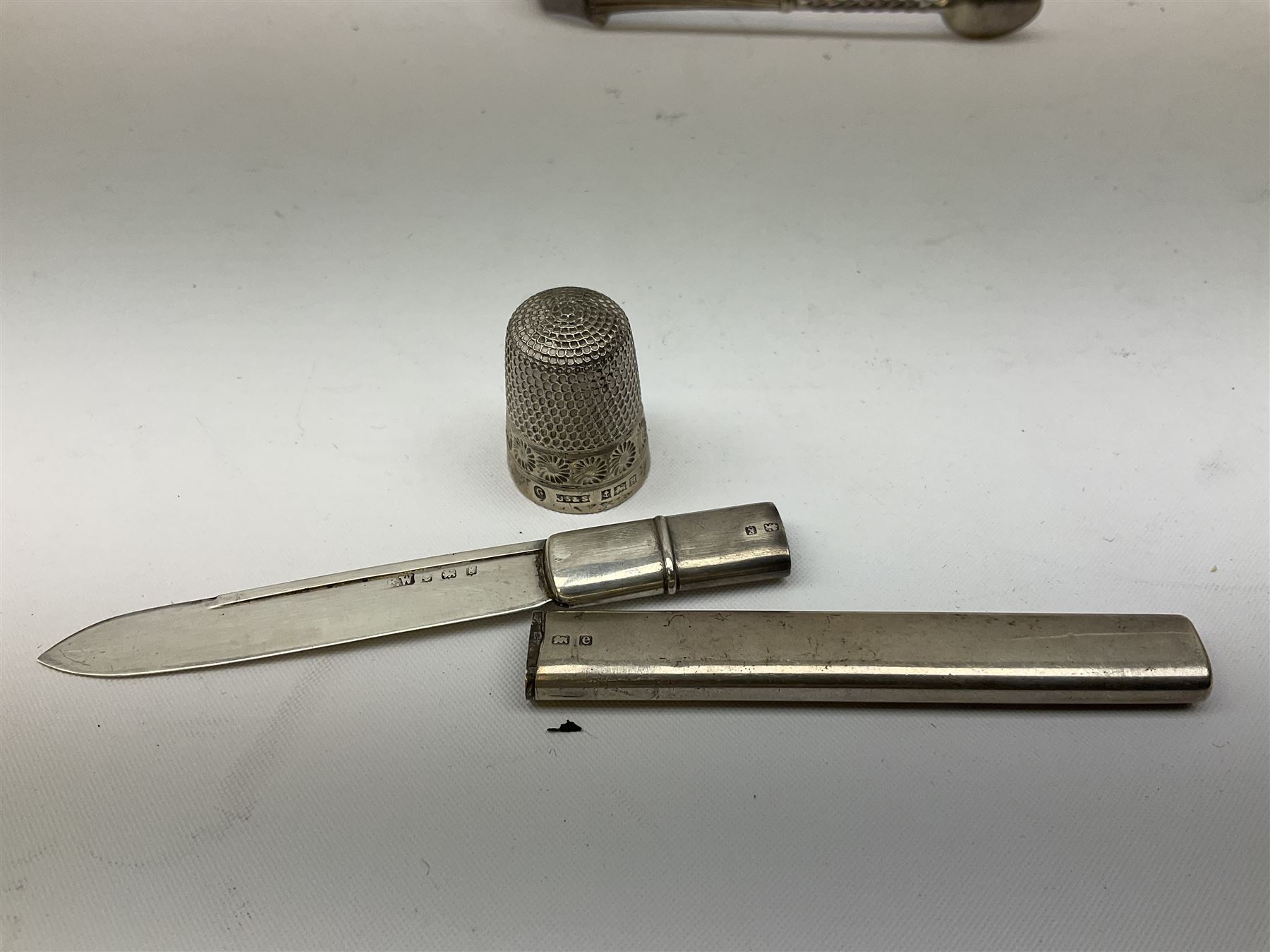 Small group of silver, to include Georgian Fiddle pattern teaspoon, later teaspoon, sugar tongs, etc., all hallmarked, approximate weighable silver 59 grams, approximate gross weight 113 grams