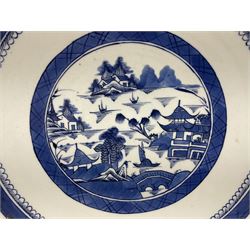 19th century Chinese export blue and white charger, decorated with waterside landscape set with pagodas, huts, bridge, fishing vessels and willow and pine trees, within trellis borders, the underside rim decorated with bamboo fronds, D38cm