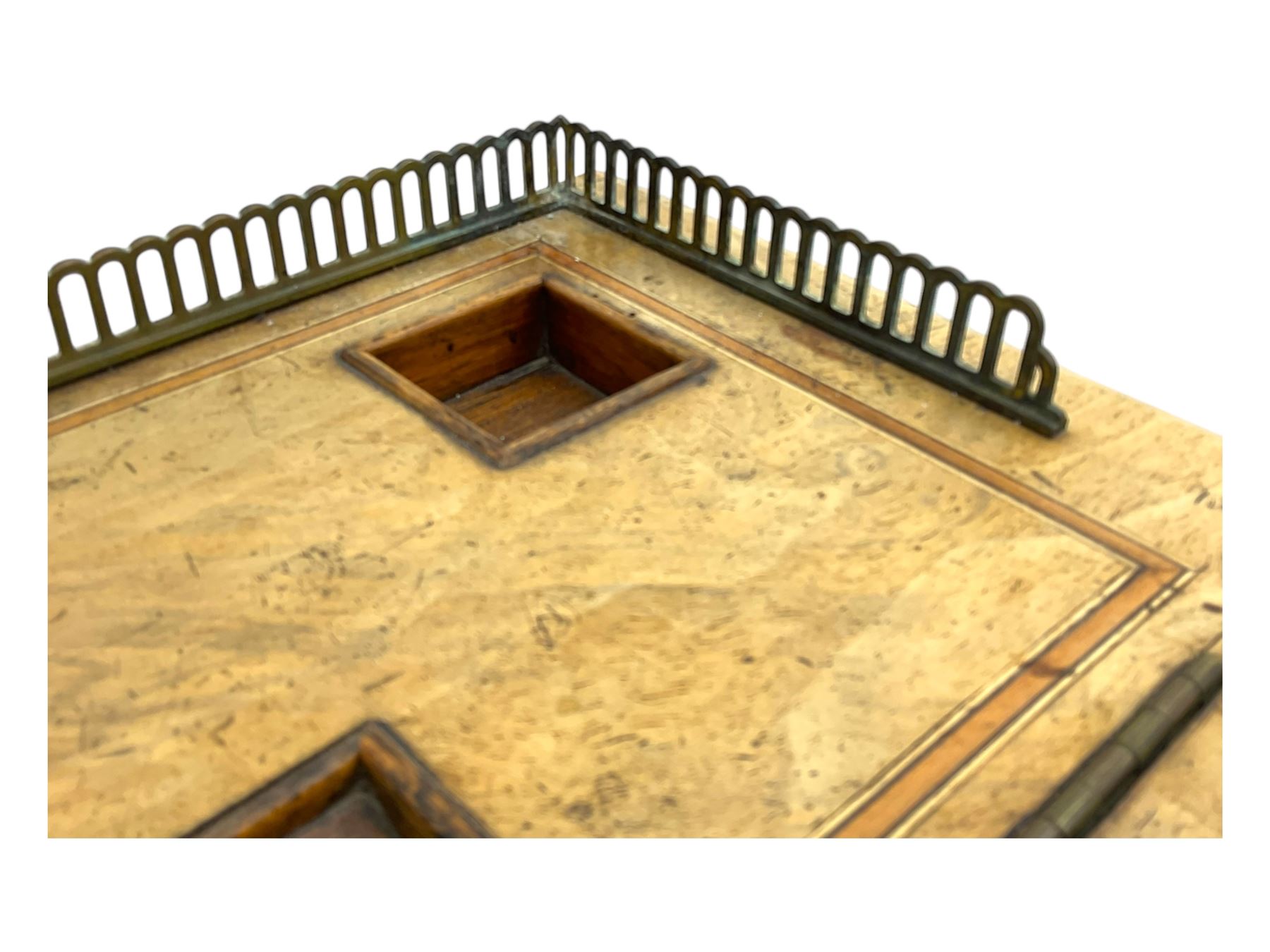 Early 19th century burr walnut Davenport desk, sloped leather-inset writing surface with brass gallery, fitted with an inkwell compartment and pen slot, four drawers to one side, raised on scrolled supports terminating in castors