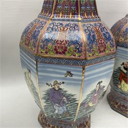 Pair of 20th century Chinese vases, of octagonal baluster form, each central panel decorated with one of The Eight Immortals, bordered by panels of floral motifs upon a pink/purple ground, H33.5cm