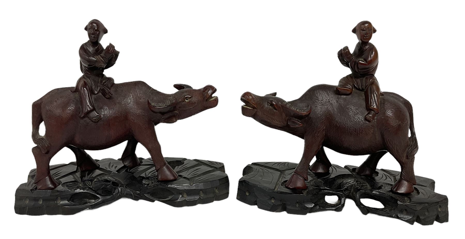 Pair of Chinese hardwood figures of farmers riding water buffalo, on stands, H19cm