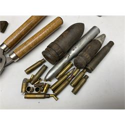 Assorted militaria including ten leather or canvas cartridge and other belts, maroon beret with 17th Lancers cap badge, modern bullet mould, leather and brass shot flask, two knives, shell cases, boomerang etc; in tin deed box